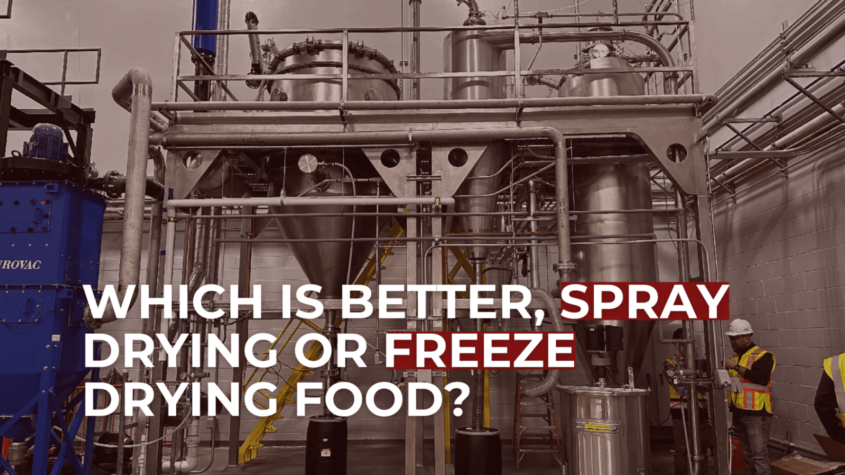 An industrial facility filled with large metal spray drying equipment and a worker in the background, with overlaid text asking 'WHICH IS BETTER, SPRAY DRYING OR FREEZE DRYING FOOD?'