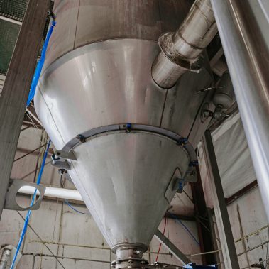 Detailed view of a large industrial cyclone separator integrated into a spray drying system, showcasing efficient powder collection and industrial drying solutions.