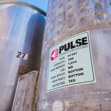 A detailed label on a stainless steel tank from Pulse Combustion Systems, specifying its capacity and features, highlighting our robust spray drying systems.