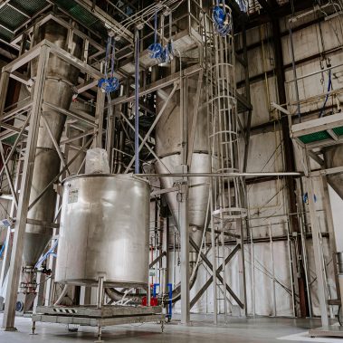 An expansive industrial spray dryer system with stainless steel tanks and cyclones, showcasing advanced spray drying equipment for efficient powder production.