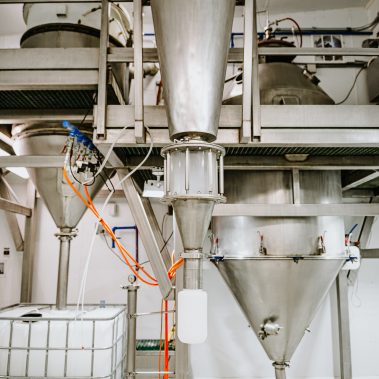 A hygienic spray dryer system made of stainless steel in a clean-room environment, detailing the powder collection cyclones of the spray drying equipment.