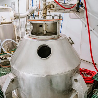 A detailed close-up of a spray dryer atomizer and the main chamber of a pulse combustion system, highlighting the core of the industrial drying equipment.