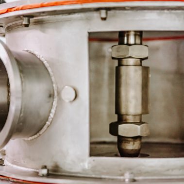 A detailed close-up of a spray dryer atomizer, showcasing the robust stainless steel engineering and core mechanics of our advanced pulse combustion systems.