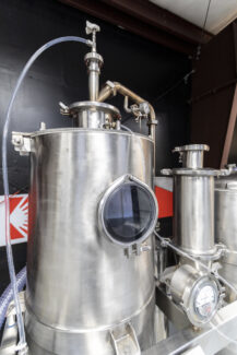 Detailed view of a stainless steel industrial spray dryer, showcasing the robust construction of our spray drying equipment and systems.