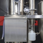 Detailed view of an industrial spray dryer system from Pulse Combustion Systems, showcasing the stainless steel construction and advanced spray drying equipment components.