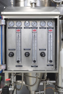Precision control panel for a Pulse Combustion Systems industrial spray dryer, showing regulators and gauges for a complete spray drying system.