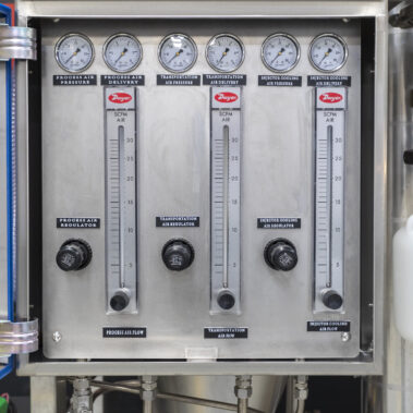 Precision control panel for a Pulse Combustion Systems industrial spray dryer, showing regulators and gauges for a complete spray drying system.