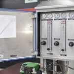 Control panel for an industrial spray dryer, showing precise airflow regulators and pressure gauges for the pulse combustion spray drying system.