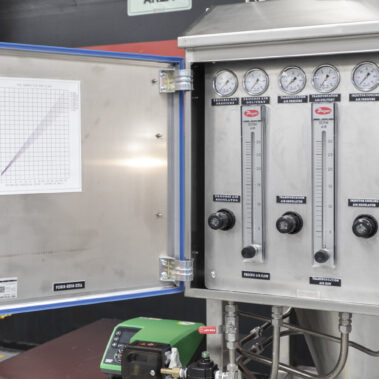 Control panel for an industrial spray dryer, showing precise airflow regulators and pressure gauges for the pulse combustion spray drying system.