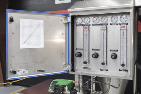 Control panel for an industrial spray dryer, showing precise airflow regulators and pressure gauges for the pulse combustion spray drying system.
