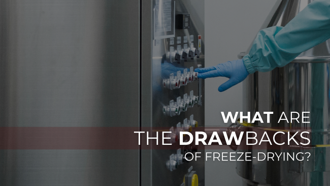 Banner Image Image of a gloved hand operating a stainless steel industrial control panel, with overlaid text asking: “What are the drawbacks of freeze-drying?” Modern and sterile lab environment, emphasizing technology and automation.