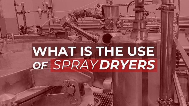 Industrial spray drying equipment with various pipes and stainless steel vessels. Overlaid white text asks: 'WHAT IS THE USE OF SPRAY DRYERS'.