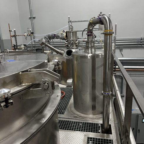 A state-of-the-art industrial spray dryer from Pulse.com, showcasing the robust stainless steel construction of our advanced spray drying systems.