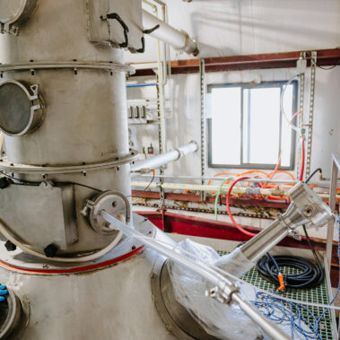 Close-up of a robust industrial spray dryer showcasing the feed inlet and drying chamber, part of the advanced spray drying systems from http://pulsedry.com/.