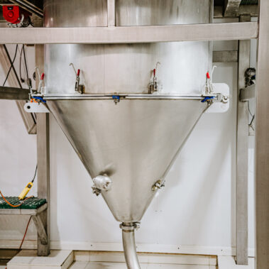 Close-up of a stainless steel conical collection chamber on an industrial spray dryer, a key component in an efficient powder drying system.
