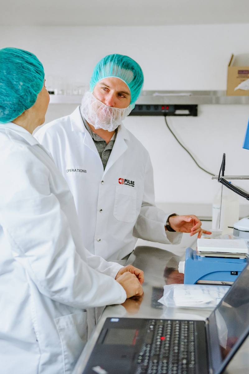Pulse Drying Systems operations team reviewing a powder sample in the R&D lab